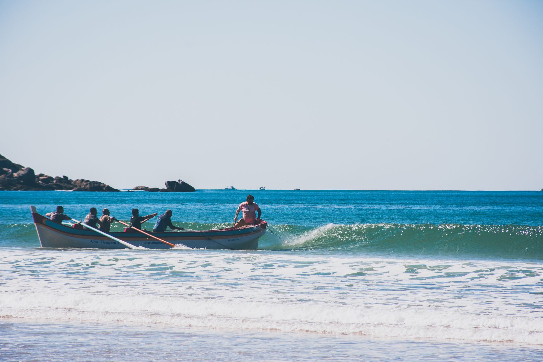 Boat cresting the break, oars up