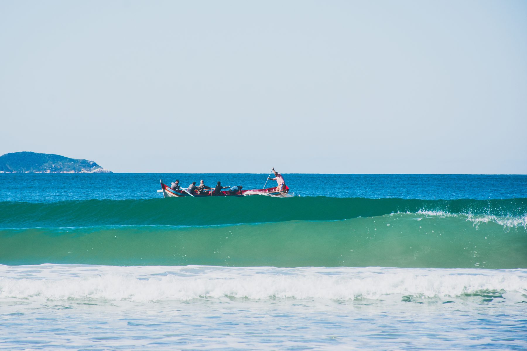 Boat rowing on steady blue water