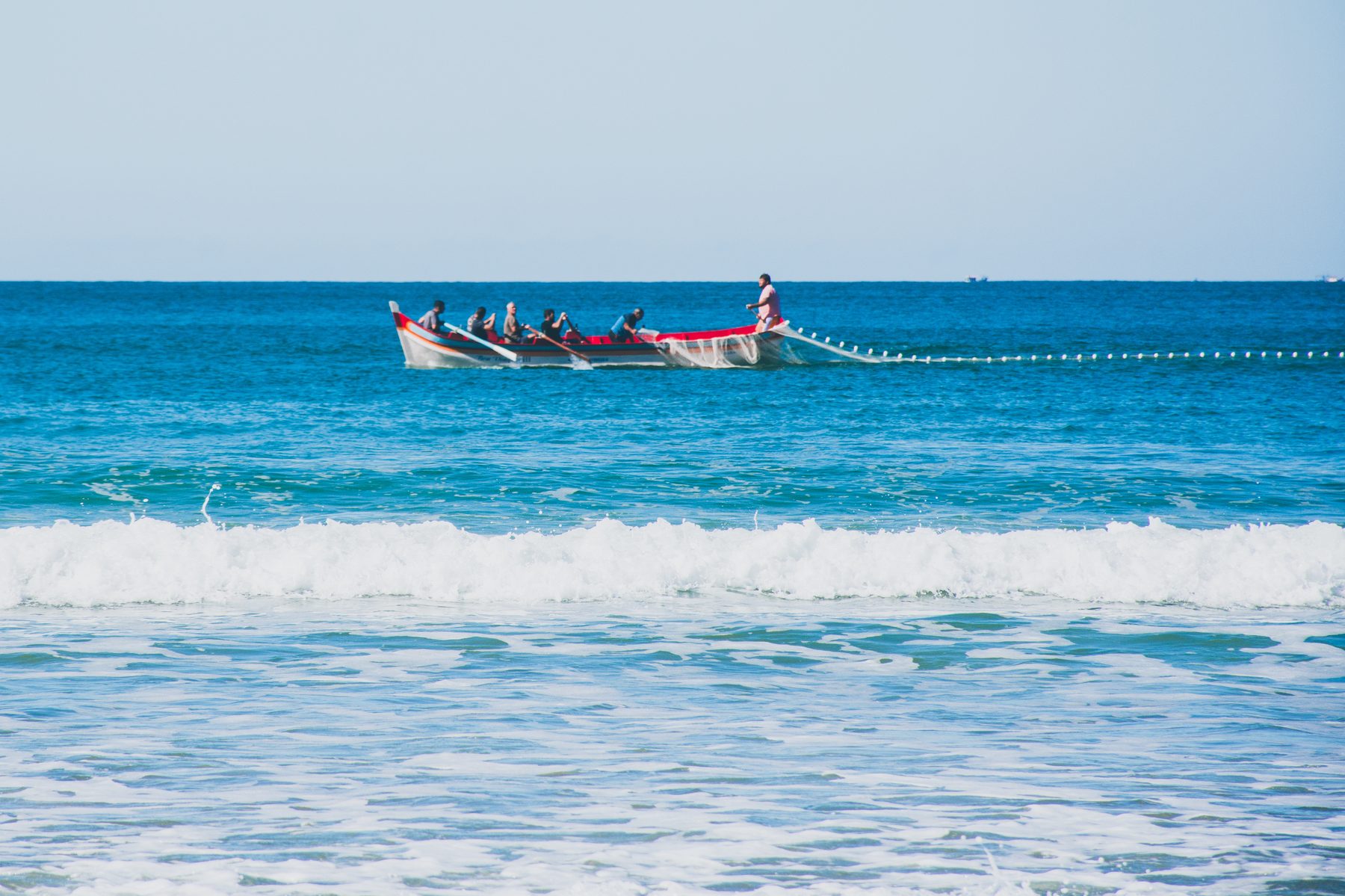 Green wall of water rising behind the boat